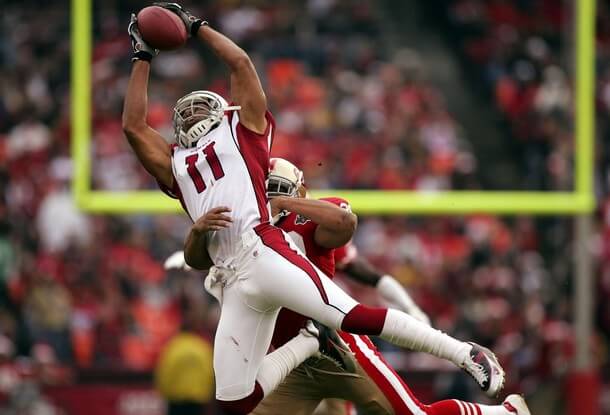 SAN FRANCISCO - DECEMBER 24: Larry Fitzgerald #11 of the Arizona Cardinals catches a pass over Keith Lewis #28 of the San Francisco 49ers during an NFL game at Monster Park on December 24, 2006 in San Francisco, California. (Photo by Jed Jacobsohn/Getty Images) *** Local Caption *** Larry Fitzgerald;Keith Lewis