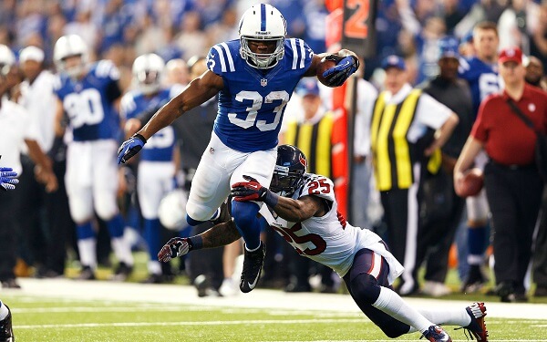 INDIANAPOLIS, IN - DECEMBER 30: Vick Ballard #33 of the Indianapolis Colts runs through a tackle by Kareem Jackson #25 of the Houston Texans during the game at Lucas Oil Stadium on December 30, 2012 in Indianapolis, Indiana. (Photo by Joe Robbins/Getty Images)